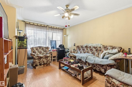 Living area featuring light wood-type flooring and ceiling fan - 10332 82 Street, Edmonton, AB - Indoor Photo Showing Living Room
