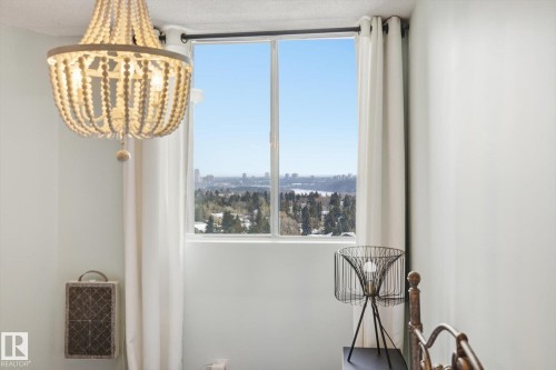 Living area with a chandelier and a city view - 1513 13910 Stony Plain Road, Edmonton, AB - Indoor Photo Showing Other Room