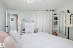 Bedroom with a chandelier and a textured ceiling - 