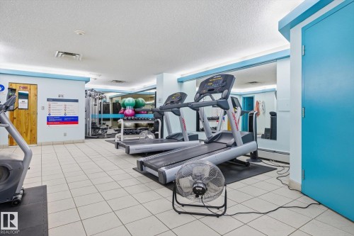 Gym featuring baseboard heating and a textured ceiling - 1513 13910 Stony Plain Road, Edmonton, AB - Indoor Photo Showing Gym Room