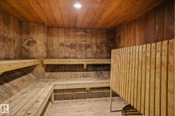 Sauna with wooden ceiling, wood walls, and recessed lighting - 
