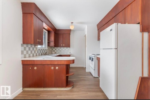 Kitchen featuring open shelves, a peninsula, white appliances, and light wood finished floors - 3810 110 Avenue, Edmonton, AB - Indoor Photo Showing Kitchen