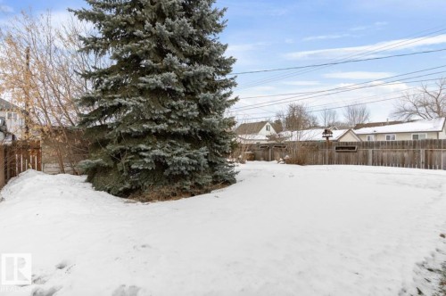 Yard covered in snow featuring a fenced backyard and a residential view - 3810 110 Avenue, Edmonton, AB - Outdoor