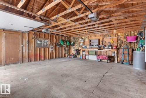 Garage with a garage door opener and wood walls - 3810 110 Avenue, Edmonton, AB - Indoor Photo Showing Garage