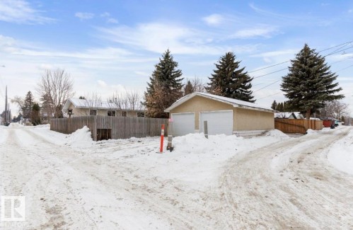 Yard layered in snow with an outdoor structure and a detached garage - 3810 110 Avenue, Edmonton, AB - Outdoor