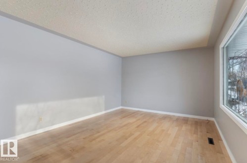 Spare room featuring light wood finished floors and a textured ceiling - 3810 110 Avenue, Edmonton, AB - Indoor Photo Showing Other Room