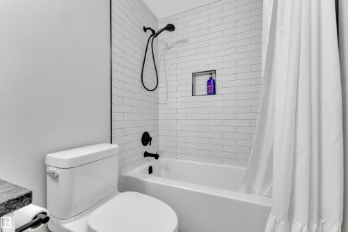 Bathroom with shower / bathtub combination with curtain and toilet - 7613 16 Ave Sw, Edmonton, AB - Indoor Photo Showing Bathroom