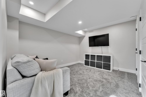 Living area with carpet flooring and recessed lighting - 7613 16 Ave Sw, Edmonton, AB - Indoor