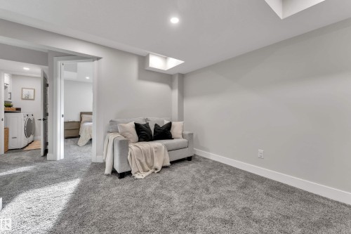 Living area with carpet, washer / dryer, and recessed lighting - 7613 16 Ave Sw, Edmonton, AB - Indoor