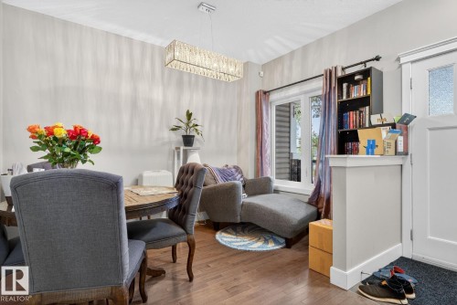 Dining room featuring wood finished floors and a chandelier - 9858 72 Avenue, Edmonton, AB - Indoor