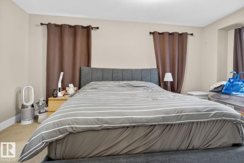 Bedroom with carpet floors and baseboards - 9858 72 Avenue, Edmonton, AB - Indoor Photo Showing Bedroom