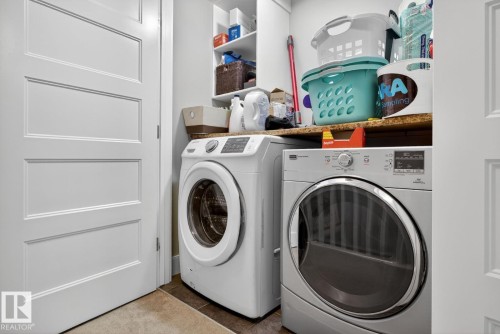 Laundry room featuring washing machine and dryer and tile patterned flooring - 9858 72 Avenue, Edmonton, AB - Indoor Photo Showing Laundry Room