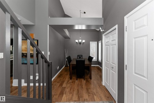 Dining room with laminate flooring, high vaulted ceiling, and a chandelier - 5628 188A Street, Edmonton, AB - Indoor Photo Showing Other Room