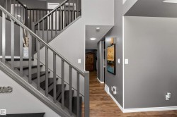 Staircase featuring laminate flooring and a high ceiling - 
