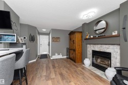 Family room with laminate flooring, and a fireplace with flush hearth - 