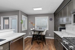 Kitchen featuring light stone countertops, stainless steel appliances, laminate flooring - 