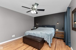 Spacious primary bedroom with an accent wall, laminate flooring, 4-piece ensuite and walk-in closet - 