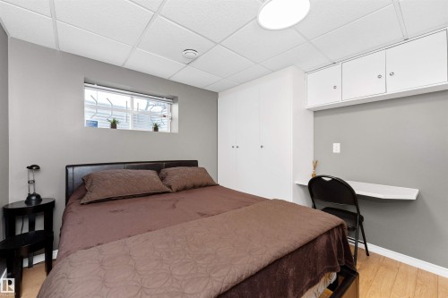basement bedroom with laminate flooring, built-in storage and desk space - 5628 188A Street, Edmonton, AB - Indoor Photo Showing Bedroom