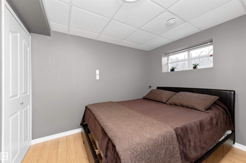 basement bedroom with laminate flooring, built-in storage and desk space - 5628 188A Street, Edmonton, AB - Indoor Photo Showing Bedroom
