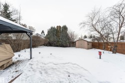 Yard featuring a platform deck, steel gazebo, and storage shed - 