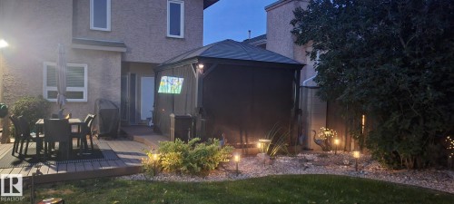 Back of property with a gazebo, stucco siding, outdoor dining area, and a deck - 5628 188A Street, Edmonton, AB - Outdoor