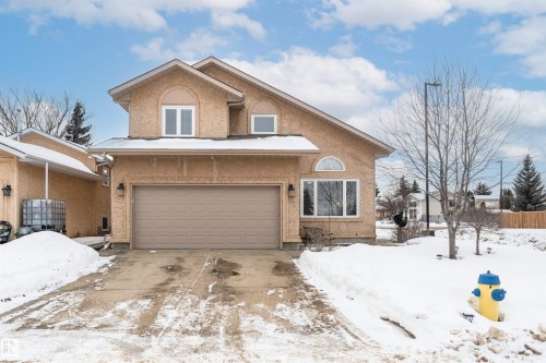 View of front of house with an attached garage, stucco siding, and concrete driveway - 5628 188A Street, Edmonton, AB - Outdoor