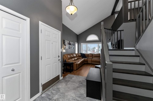 Foyer with stairway, high vaulted ceiling, and dark wood-style floors - 5628 188A Street, Edmonton, AB - Indoor Photo Showing Other Room