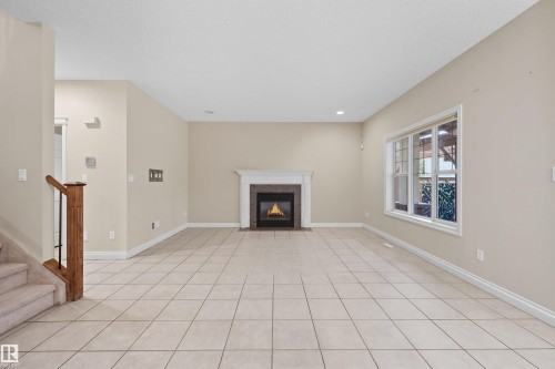 976 Hollingsworth Bend, Edmonton, AB - Indoor Photo Showing Other Room With Fireplace