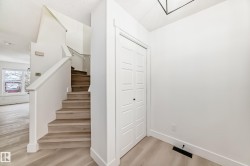 Stairway with wood finished floors and baseboards - 