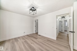 Unfurnished bedroom with baseboards and light wood-type flooring - 