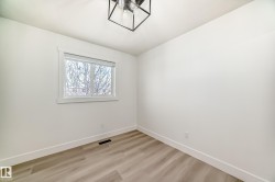 Spare room featuring baseboards and light wood-style flooring - 