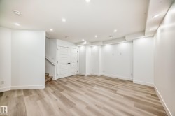 Basement with stairway, light wood-type flooring, and recessed lighting - 