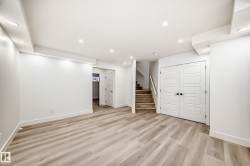 Finished basement with stairway, recessed lighting, and light wood-style floors - 