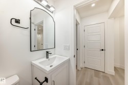 Half bath featuring vanity, light wood-style flooring, and recessed lighting - 
