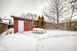 Snow covered house with a fenced backyard - 