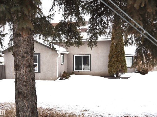 Snow covered back of property with stucco siding - 4511 53 Ave, Barrhead, AB - Outdoor