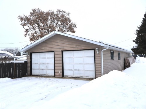 Snow covered garage with a detached garage - 4511 53 Ave, Barrhead, AB - Outdoor