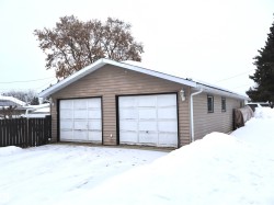Snow covered garage with a detached garage - 