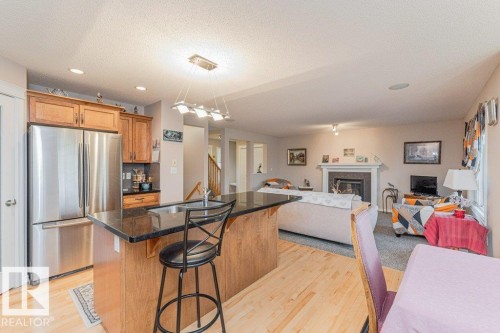 6227 5 Avenue, Edmonton, AB - Indoor Photo Showing Kitchen With Fireplace With Stainless Steel Kitchen