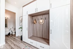 Mudroom with light wood-style floors - 