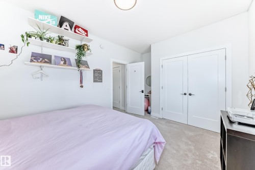 Bedroom featuring light colored carpet and a closet - 8321 80 Avenue, Edmonton, AB - Indoor Photo Showing Bedroom