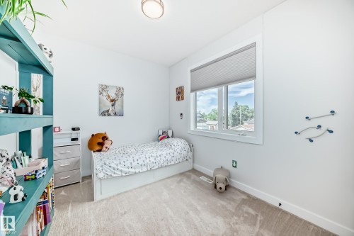 Bedroom with light carpet and baseboards - 8321 80 Avenue, Edmonton, AB - Indoor Photo Showing Bedroom