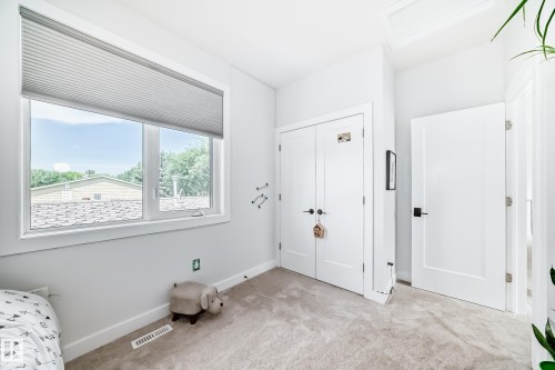Unfurnished bedroom featuring carpet, attic access, and a closet - 8321 80 Avenue, Edmonton, AB - Indoor