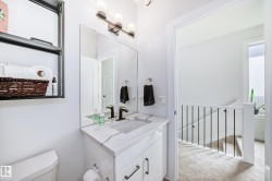 Half bathroom featuring vanity and light colored carpet - 