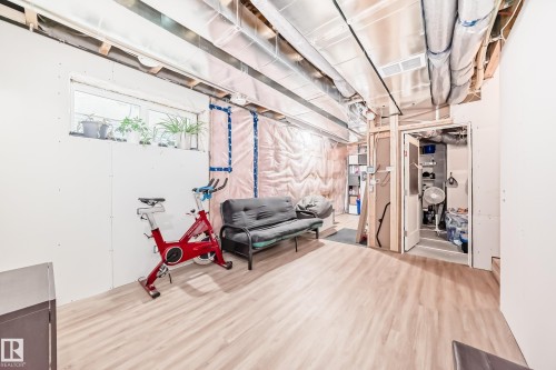 Unfinished below grade area with wood finished floors - 8321 80 Avenue, Edmonton, AB - Indoor