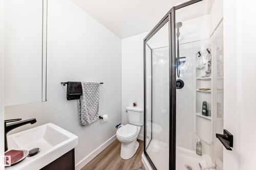 Full bathroom with a shower stall, light wood-type flooring, and vanity - 8321 80 Avenue, Edmonton, AB - Indoor Photo Showing Bathroom