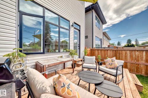 Wooden terrace with an outdoor living space - 8321 80 Avenue, Edmonton, AB - Outdoor With Deck Patio Veranda