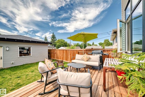 Wooden terrace with an outdoor hangout area and a fenced backyard - 8321 80 Avenue, Edmonton, AB - Outdoor With Deck Patio Veranda With Exterior