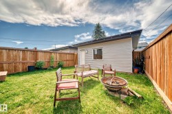 Back of house with a fire pit and a fenced backyard - 