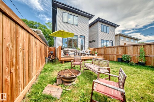 Rear view of property featuring a fire pit, a deck, and a fenced backyard - 8321 80 Avenue, Edmonton, AB - Outdoor With Deck Patio Veranda With Exterior